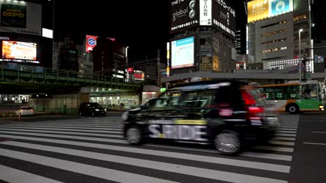 City-neon-lights-at-busy-Shinjuku-pedestrian-road-safety-zebra-crossing