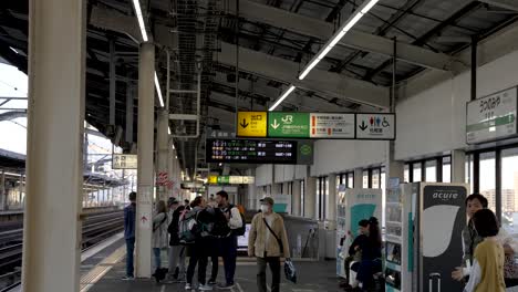 Passengers-waiting-on-Japanese-station-platform-for-public-transit