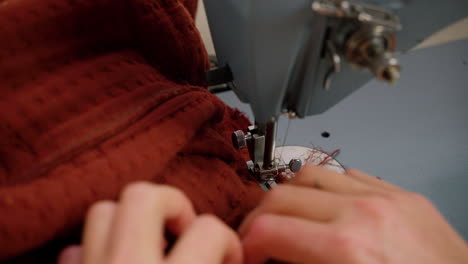 Close-up-sewing-machine-sewing-fabric-with-needle-and-thread