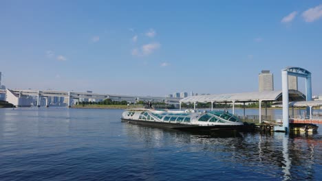 Tokyo-Bay-at-Odaiba,-Water-Taxi-in-harbor-on-beautiful-sunny-day-in-Japan-4k