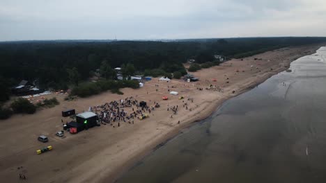 Aerial-drone-view-of-a-party-outdoors-in-beatch-at-day
