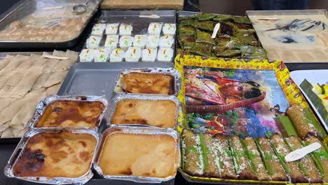 Traditional-Bengali-Sweets-like-malpua,-sandesh,-patisapta-and-baked-sandesh-and-doi-in-a-local-roadside-shop-in-Kolkata
