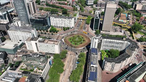 The-drone-is-rotating-around-a-big-and-busy-roundabout-in-the-middle-of-the-city-centre-of-Rotterdam-The-Netherlands-Aerial-Footage-4K