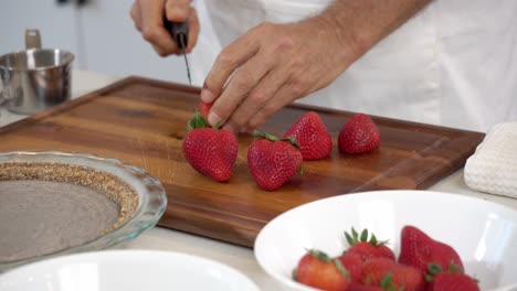 Cutting-strawberries-adding-in-bowl-to-make-homemade-dairy-free-vegan-plant-based-cheesecake-diet-healthy-eating