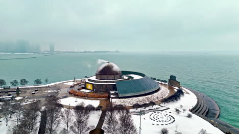 Aerial-view-around-the-Adler-Planetarium,-foggy,-winter-day-in-Chicago,-USA