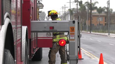 firefighter-putting-gear-in-truck