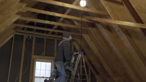 Carpenter-Cutting-On-A-Ladder-Cutting-Wood-With-Circular-Saw