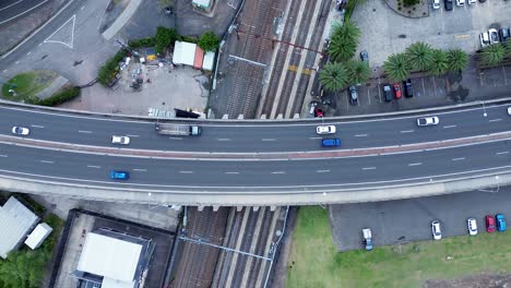 Drone-aerial-scenic-view-cars-and-truck-on-Brian-McGowan-bridge-Gosford-train-station-carpark-waterfront-travel-transport-Central-Coast-Australia