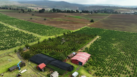 Aerial-view-circling-a-maze-garden,-in-rural-Puebla,-cloudy-day-in-Mexico