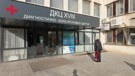 Old-people-walking-in-and-out-of-a-Clinic-in-Sofia,-Bulgaria