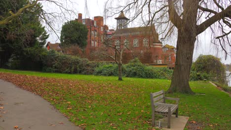 Profile-view-of-an-empty-park-with-The-Radnor-House-at-background-during-autumn-in-Twickenham-district-in-London,-England