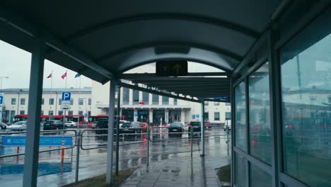 Passenger-tunnel-outdoors-of-Vilnius-Airport-during-daytime-in-rain-pov