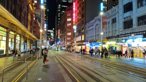 Tilt-down-view-of-George-street-Sydney-with-light-rail-tram-arriving-at-Queen-Victoria-Building-stop