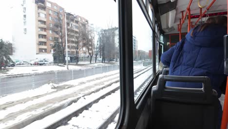 POV-footage-from-inside-tram-number-22,-on-a-bright-winter-day,-a-woman-gets-up-from-her-seat