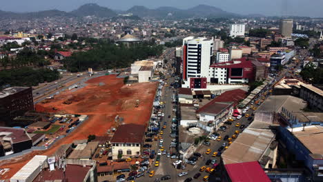 Aerial-view-rising-over-the-cityscape-of-downtown-Yaounde,-sunny-Cameroon,-Africa