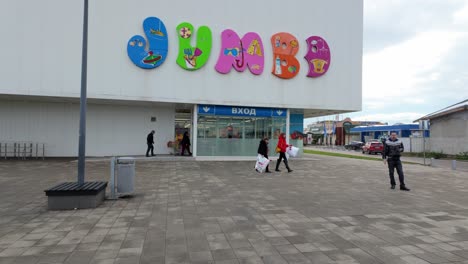 People-at-The-entrance-of-the-Jumbo-store-at-Jumbo-Plaza-on-a-cloudy-winter-day