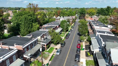 Aerial-view-of-a-tree-lined-residential-street-with-row-houses-and-parked-cars