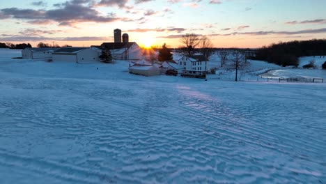 Rural-American-farm-scene-in-winter-snow-at-sunrise