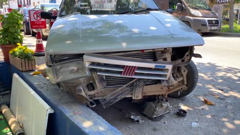 Old-car-crashed-and-destroyed-near-sidewalk-in-Turkey,-big-dangerous-accident,-old-broken-car-on-the-road,-car-insurance-damage,-4K-shot