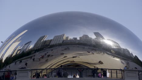 Reflective-view-of-Chicago-skyline-in-the-Bean-sculpture-at-Millennium-Park-with-visitors-around