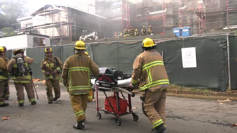firefighters-bring-out-medical-equipment