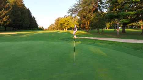 Golf-course-green-with-flag-in-hole
