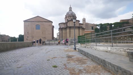 Speed-Walking-Towards-Ancient-Ruins-|-Rome-Immersive-POV:-Moving-In-Busy-Streets-to-Chiesa-Santi-Luca-e-Martina,-Italy,-Europe,-Walking,-Shaky,-4K
