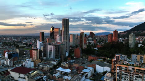 Aerial-view-flying-over-of-high-rise-in-downtown-Bogota,-sunset-in-Colombia