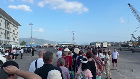 Scene-of-long-waiting-lines-and-cruise-passengers-queuing-to-take-the-tender-boat-back-to-Cruise-in-Nha-Trang,-Vietnam