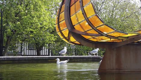 Slow-motion-of-seagulls-enjoying-a-dip-at-the-Leaf-Boat-statue-in-Swansea