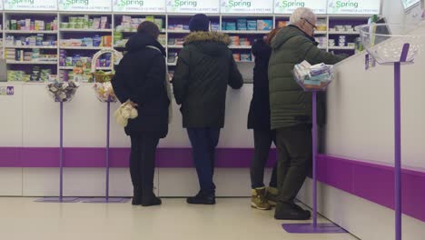 People-Waiting-At-Drugstore-Shop-Counter