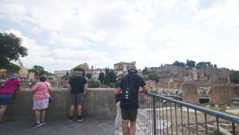 Travelers-Standing-Near-Ancient-Ruins-|-Rome-Immersive-POV:-Moving-In-Busy-Streets-to-Chiesa-Santi-Luca-e-Martina,-Italy,-Europe,-Walking,-Shaky,-4K
