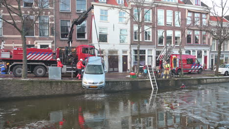 Winter-recovery-operation-performed-by-firefighter-brigade-of-a-car-sinked-into-the-frozen-city-canal