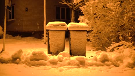 Garbage-cans-are-standing-in-the-snow-in-winter