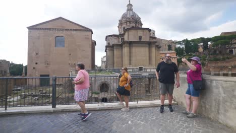 Group-of-Travelers-Viewing-Ancient-Ruins-|-Rome-Immersive-POV:-Moving-In-Busy-Streets-to-Chiesa-Santi-Luca-e-Martina,-Italy,-Europe,-Walking,-Shaky,-4K
