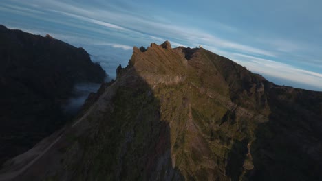 FPV-drone-cruising-in-the-mountains-in-proximity-to-the-ridgeline-over-the-clouds-at-Madeira