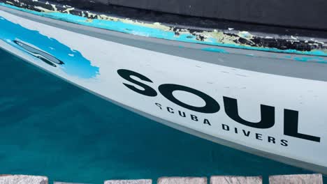 Close-up-of-Soul-Scuba-Divers-company-name-and-logo-on-dive-boat-in-Raja-Ampat,-West-Papua,-Indonesia