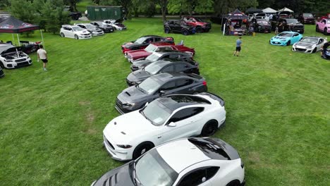 Aerial-view-of-sport-car-show-and-enthusiast-meet-in-park,-community-car-culture