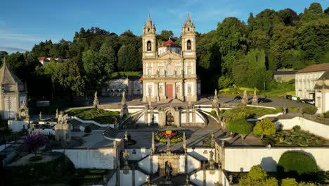 Two-Persons-Jogging-Up-Bom-Jesus-Stairs-in-Braga,-Northern-Portugal,-During-Sunset,-Aerial-Shot