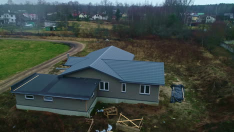 Aerial-view-around-a-newly-constructed-house,-modern-home,-on-a-rainy-fall-day