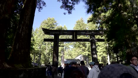 Stone-Torii-Gate-Leading-To-Entrance-To-Nikko-Toshogu-With-Queue-Of-People