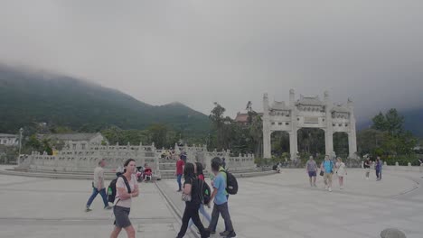 Ngong-Ping-Village-main-plaza-as-tourists-and-visitors-take-pictures-and-walk-round-during-an-overcast-day---Super-Slow-Motion