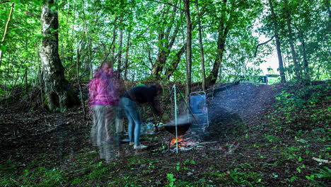A-Group-Of-People-Cooking-Outdoor-While-On-Camping-Amidst-Forest