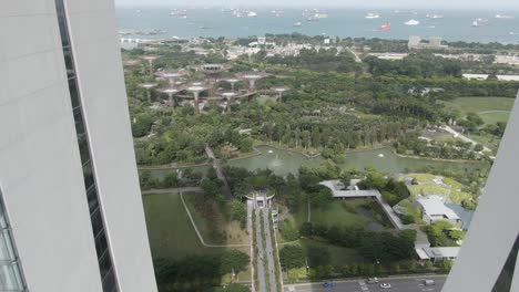 Aerial-fly-through-the-Marina-Bay-Sands-Hotel-and-reveal-Gardens-by-the-Bay-mushroom-buildings