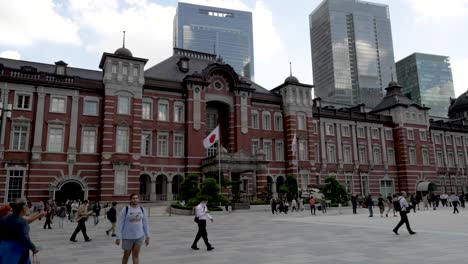 Commuters-Walking-Past-Across-Marunouchi-Square-With-Tokyo-Station-Building-In-Background