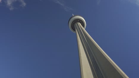 Upward-view-of-the-CN-Tower-in-Toronto-against-a-clear-blue-sky,-daytime,-iconic-landmark