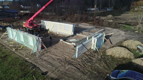 Aerial-view-of-a-crane-placing-the-panels-for-the-construction-of-a-prefabricated-house