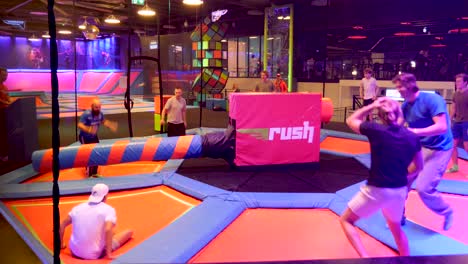 A-contest-at-an-indoor-trampoline-park-to-avoid-a-arm-that-rotates-randomly-around
