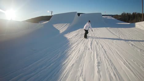 Snowboarder-makes-a-toe-side-mute-snowboard-grab---slow-motion-follow-perspective