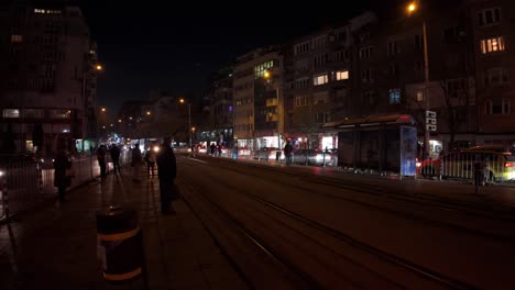 Beautiful-Night-footage-of-a-red-tram,-number-22-arriving-at-Poduyane-tram-stop-at-night